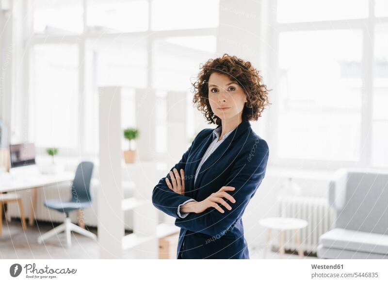 Businesswoman standing in her office with arms crossed offices office room office rooms Arms Folded Folded Arms Crossed Arms Crossing Arms Arms Clasped
