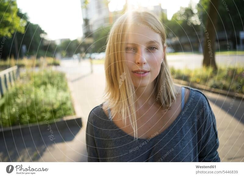 Portrait of blond young woman at backlight Backlit back light back lighting back lit females women blond hair blonde hair portrait portraits Adults grown-ups