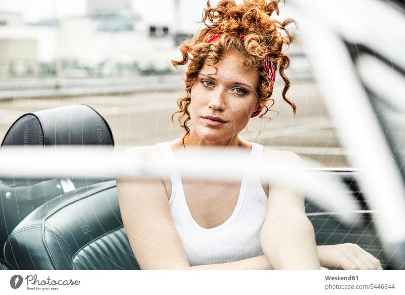 Portrait of redheaded woman in sports car females women automobile Auto cars motorcars Automobiles portrait portraits Adults grown-ups grownups adult people