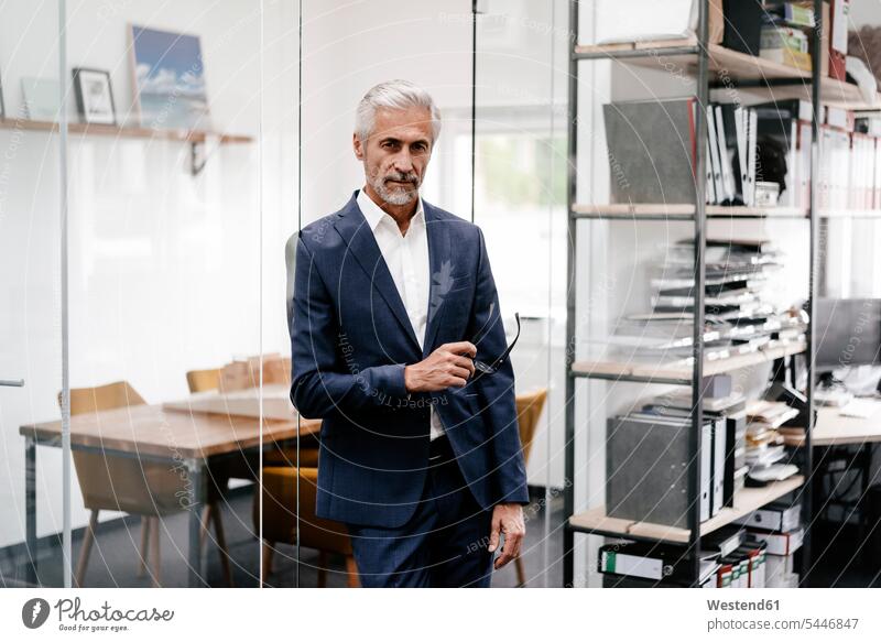 Portrait of serious mature businessman in office portrait portraits Businessman Business man Businessmen Business men offices office room office rooms