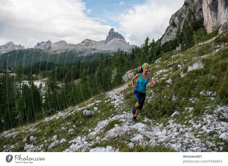 Italy, Dolomites, Veneto, trail runner at Federa Lake running athlete sportswoman athletes female athlete sportswomen female athletes mountain mountains females