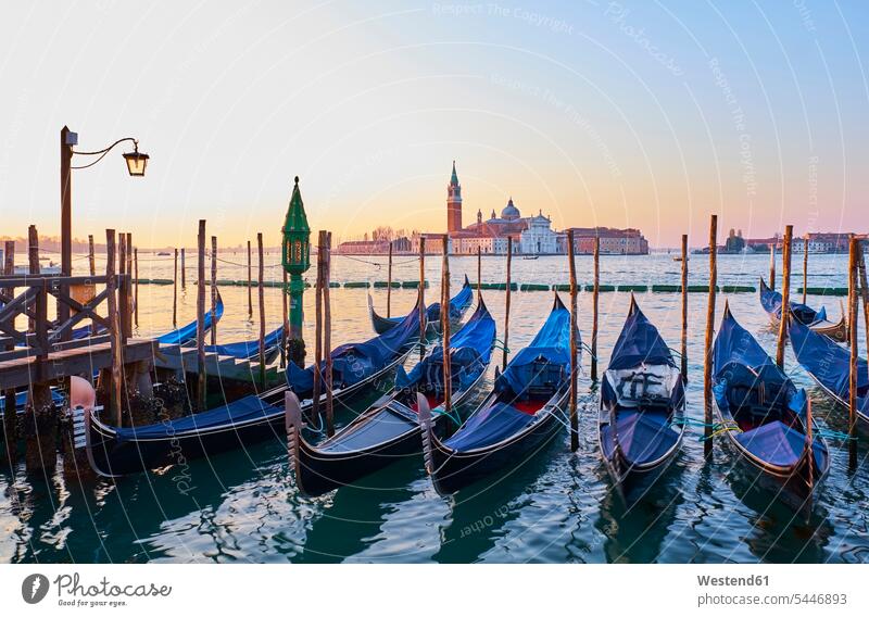Italy, Venice, View of Giudecca from St Mark's Square with gondolas landmark sight place of interest historic ancient historical dawn morning twilight