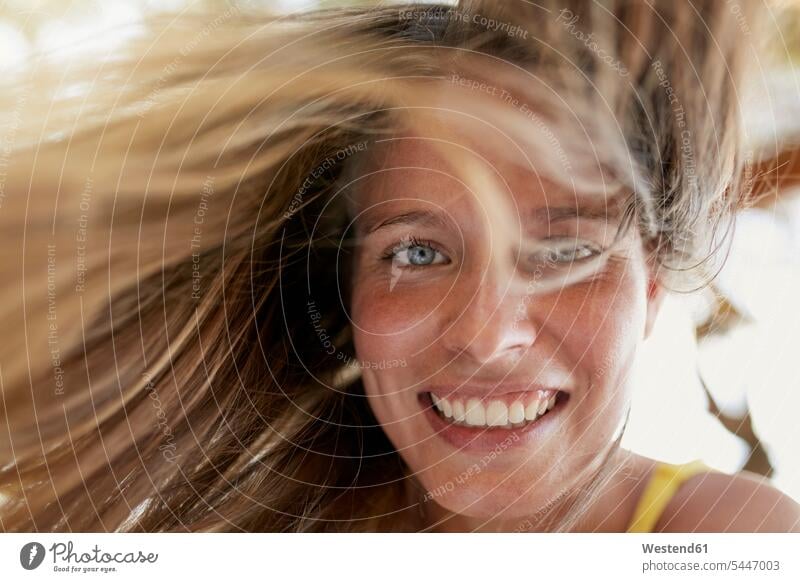 Portrait of laughing young woman with blowing hair Laughter females women portrait portraits positive Emotion Feeling Feelings Sentiments Emotions emotional