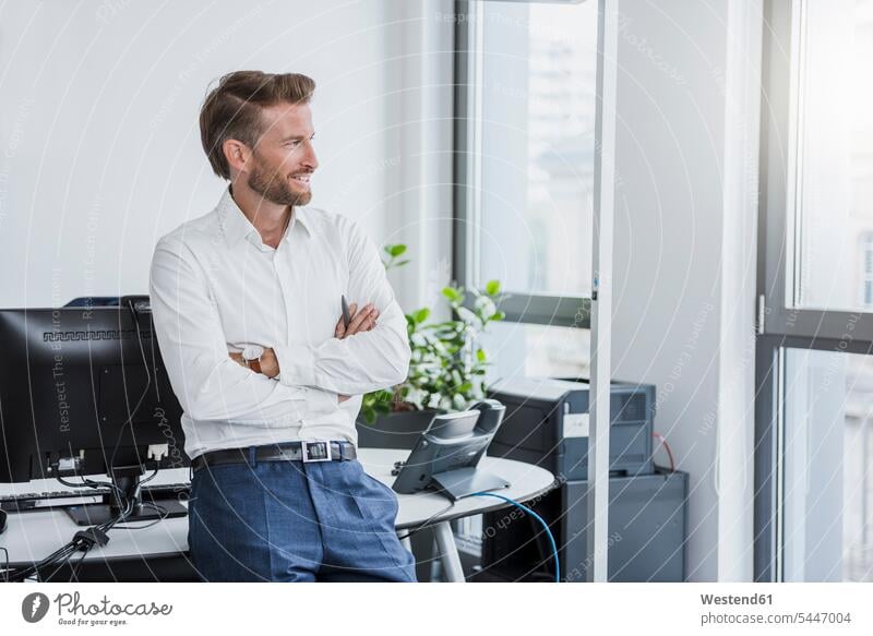 Portrait of smiling businessman with arms crossed in the office offices office room office rooms Businessman Business man Businessmen Business men workplace