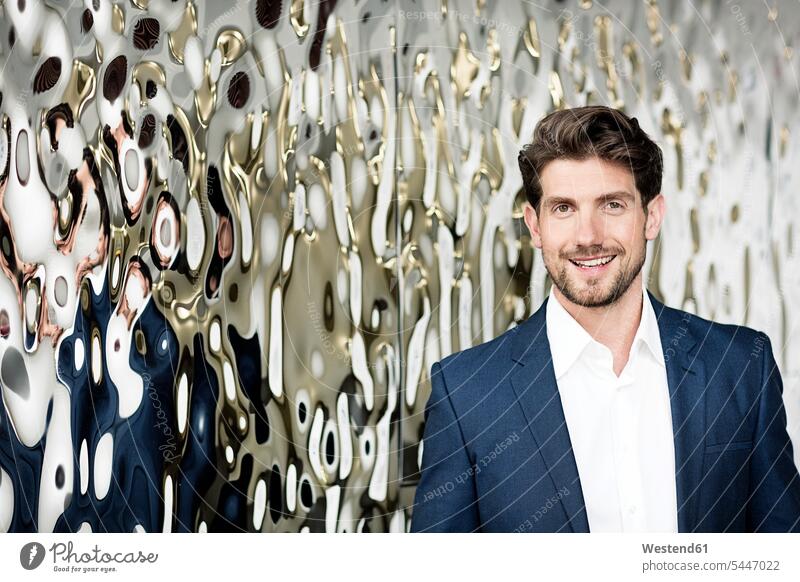 Portrait of successful businessman in front of mirrored wall portrait portraits Businessman Business man Businessmen Business men business people businesspeople