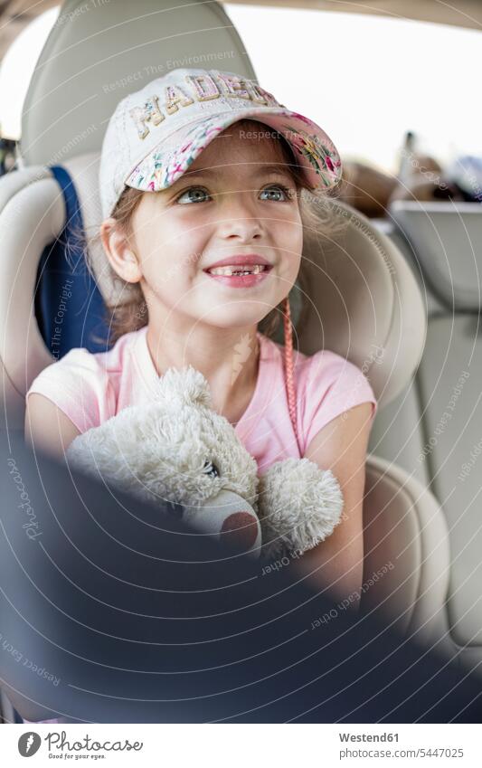Girl sitting in car, holding teddy bear automobile Auto cars motorcars Automobiles girl females girls teddy-bear teddy bears Seated Road Trip roadtrip Road-Trip