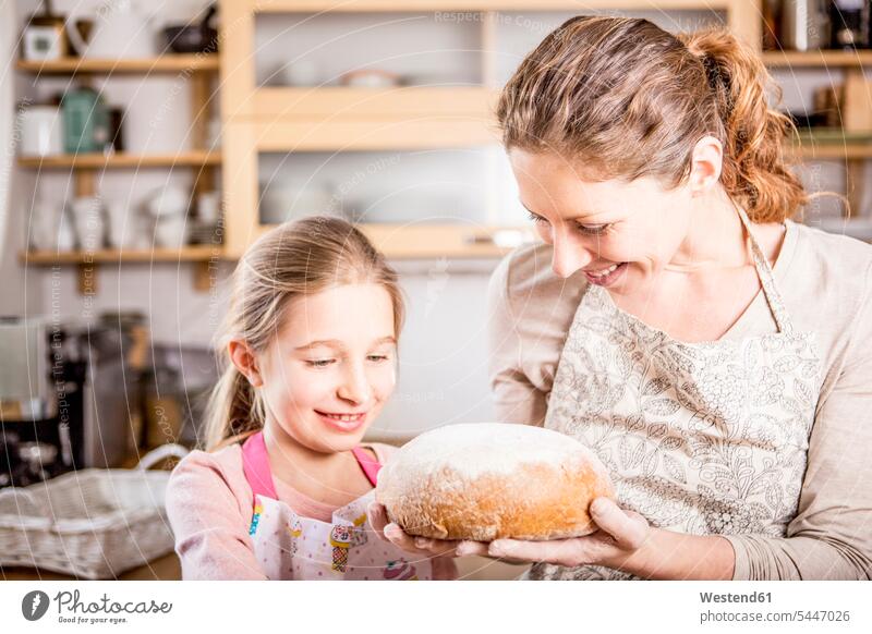 Mother and daughter baking bread in kitchen together Bread Breads bake daughters mother mommy mothers ma mummy mama domestic kitchen kitchens Food foods