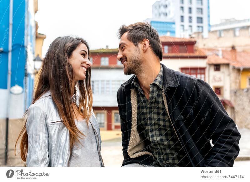 Couple smiling at each other in the city smile looking eyeing couple twosomes partnership couples view seeing viewing people persons human being humans