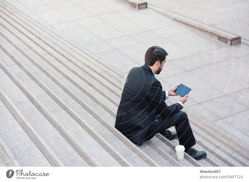 Businessman sitting on stairs with tablet and takeaway coffee break digitizer Tablet Computer Tablet PC Tablet Computers iPad Digital Tablet digital tablets