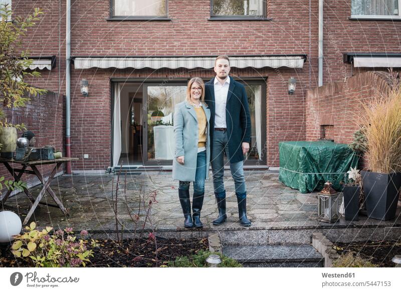 Portrait of smiling couple standing on terrace in autumn portrait portraits smile fall terraces twosomes partnership couples people persons human being humans