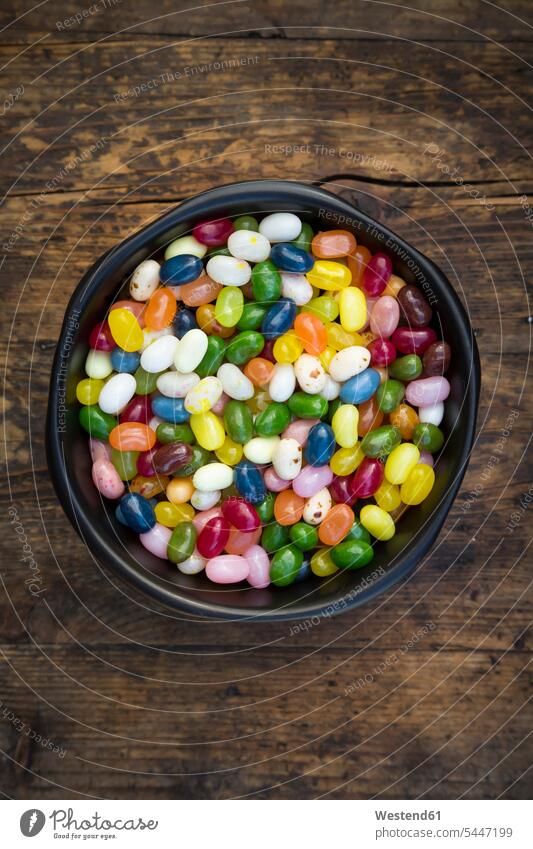 Bowl of colourful sweet jellybeans on dark wood food and drink Nutrition Alimentation Food and Drinks Sugary sweets Sweets Candies Sweet Food variation wooden