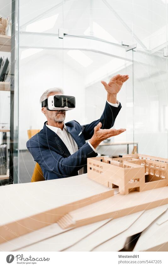 Mature businessman with architectural model in office wearing VR glasses Businessman Business man Businessmen Business men architects offices office room