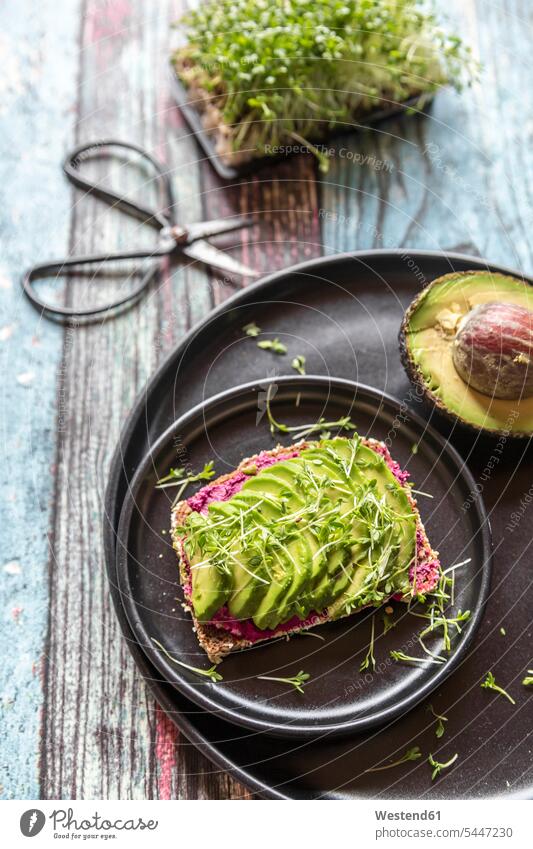 Slice of bread with beetroot hummus, slices of avocado and cress food and drink Nutrition Alimentation Food and Drinks cut hearty savoury food lusty