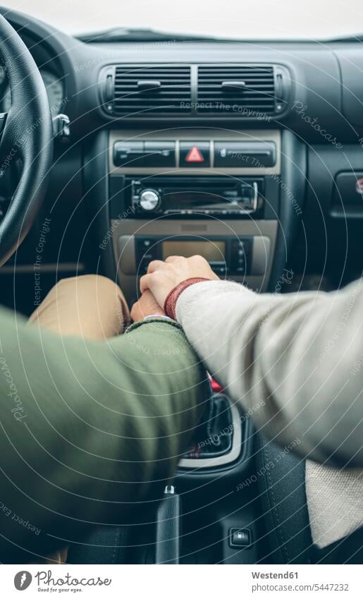 Woman putting her hand on man's hand using gear shift in car automobile Auto cars motorcars Automobiles couple twosomes partnership couples driving drive