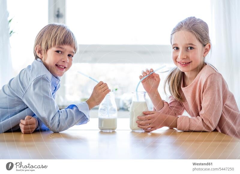 Brother and sister drinking milk brother brothers Milk sisters smiling smile siblings brother and sister brothers and sisters family families people persons