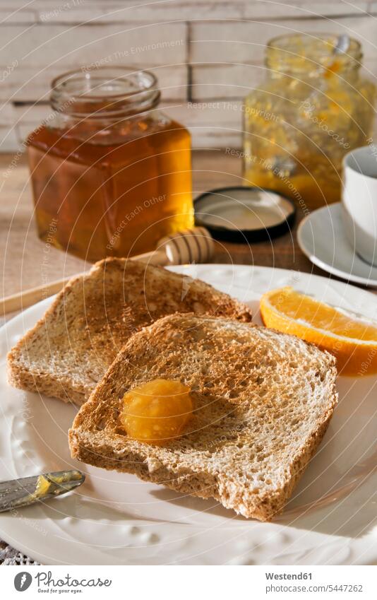 Breakfast table with toast, orange marmalade, honey and espresso Espresso sweet Sugary sweets knife knives Plate dish dishes Plates Glass Glasses Bowl Bowls