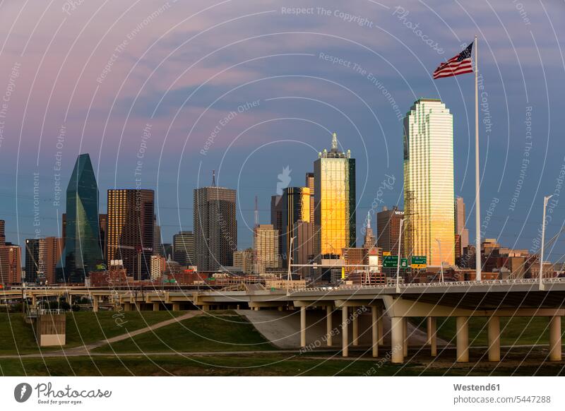 USA, Texas, Dallas skyline at dusk flag flags atmosphere atmospheric evening evening twilight bridge bridges cloudy cloudiness clouds copy space Patriotism