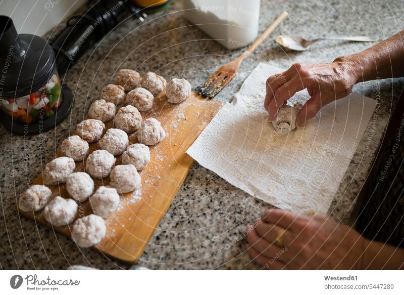 Hand of senior woman preparing meatballs in the kitchen, close-up shaping Forming hand human hand hands human hands people persons human being humans