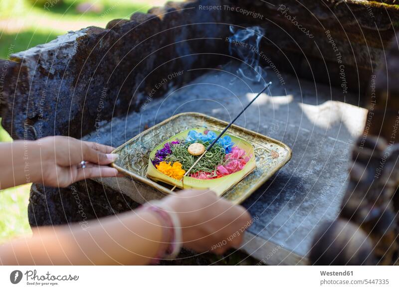 Woman serving Balinese offering praying Part Of partial view cropped basket baskets joss stick Incense Sticks joss sticks smoke Balinese Culture Travel
