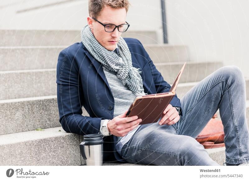 Young businessman sitting on stairs, using digital tablet urban urbanity stairway digitizer Tablet Computer Tablet PC Tablet Computers iPad Digital Tablet
