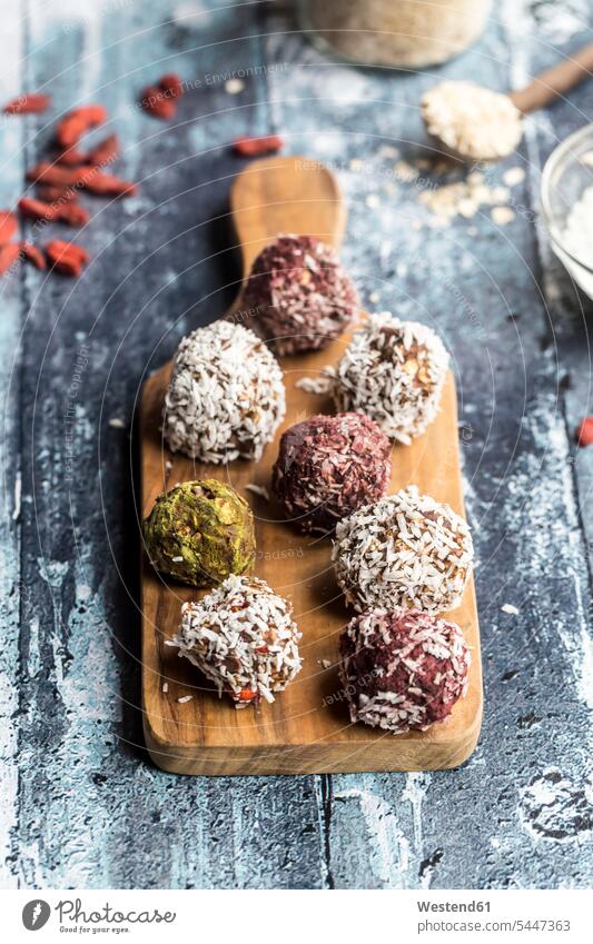 Various Bliss Balls on wooden board Energy Ball Energy Balls Glass Bowl Goji Chinese boxthorn Chinese wolfberries Lycium barbarum Chinese wolfberry Wolfberry