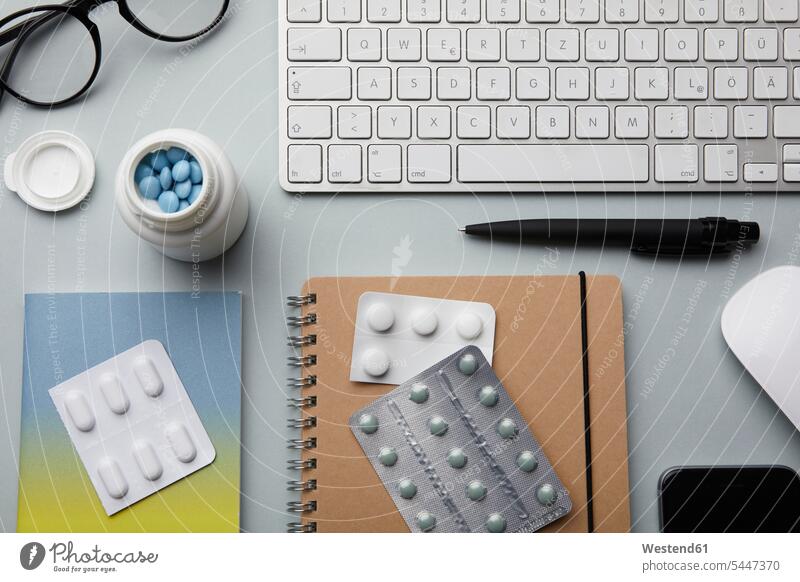 Medicine on desk nobody notepad pads Note Pad notepads Note Pads flat lay tablet Workaholic glasses specs Eye Glasses spectacles Eyeglasses office offices