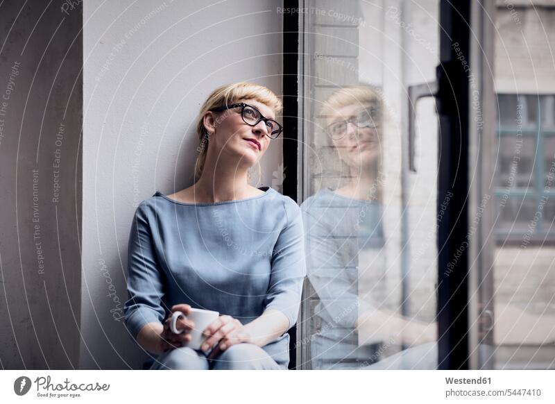 Portrait of smiling woman with coffee mug looking through window females women portrait portraits Adults grown-ups grownups adult people persons human being