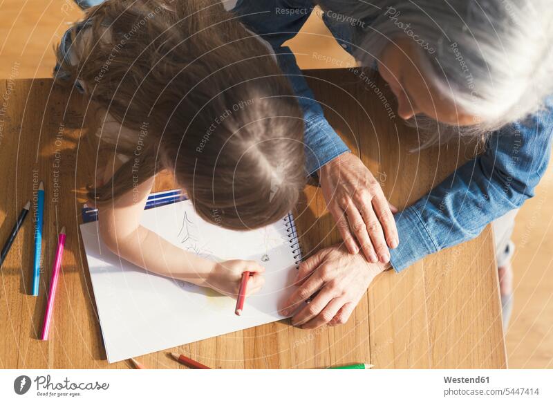 Grandmother and granddaughter making a drawing together grandmother grandmas grandmothers granny grannies painting sketching granddaughters drawings sketches