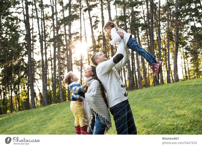 Playful family with two girls in forest happiness happy Fun having fun funny females families laughing Laughter child children kid kids people persons