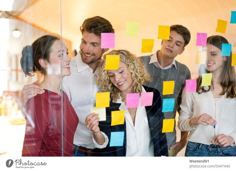 Business people discussing in front of glass screen with sticky notes business business world business life Brainstorming Adhesive Note Adhesive Notes