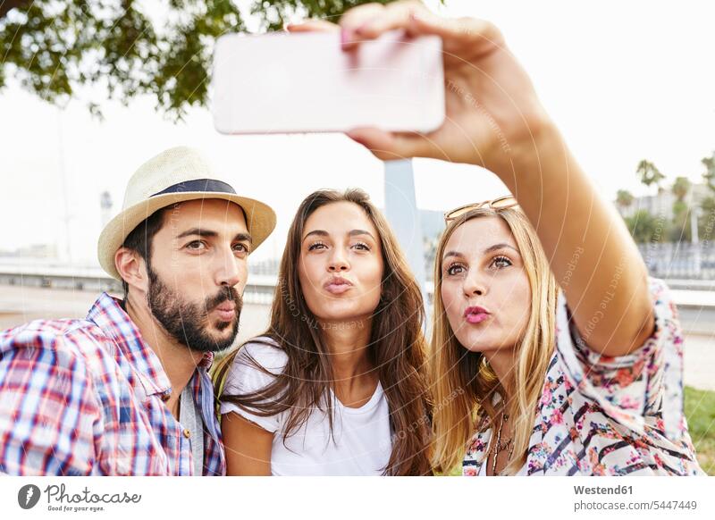 Three friends taking a selfie pouting mate Selfie Selfies mobile phone mobiles mobile phones Cellphone cell phone cell phones friendship telephones