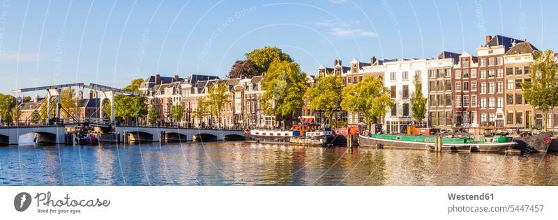 Netherlands, Amsterdam, view to Magere Brug and row of historical houses at Amstel River nobody row of houses historic old town historic city centre