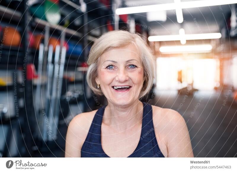 Portrait of happy senior woman in gym exercising exercise training practising portrait portraits laughing Laughter senior women elder women elder woman old