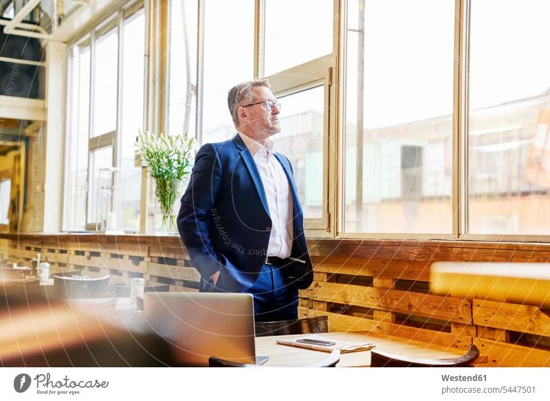 Mature businessman in cafe looking out of window Businessman Business man Businessmen Business men windows business people businesspeople business world