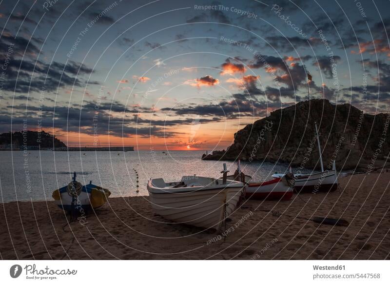 Spain, Catalonia, Blanes, beach sunrise at Mediterranean Sea seafront seashore Oceanside Sea Shore sun rise sunrises calm placid Restful serene Moody Sky
