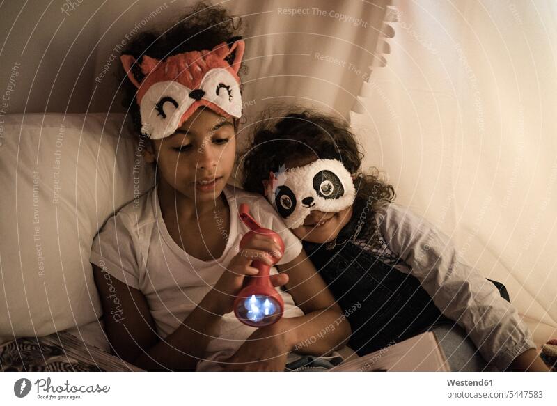 Two sisters sitting in dark children's room, playing with torch, reading book books reading out read out torches flashlight Kids Room nursery child's room
