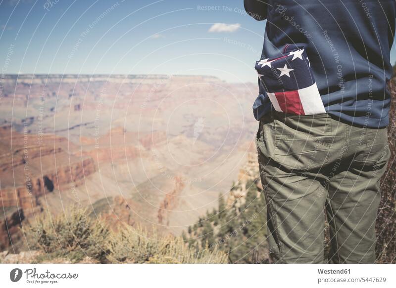USA, Grand Canyon, man with American Flag in his pocket, partial view american Stars And Stripes Star-Spangled Banner men males Adults grown-ups grownups adult