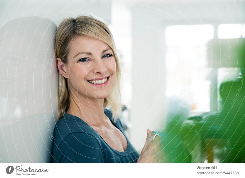 Portrait of smiling blond woman at home portrait portraits smile females women Adults grown-ups grownups adult people persons human being humans human beings