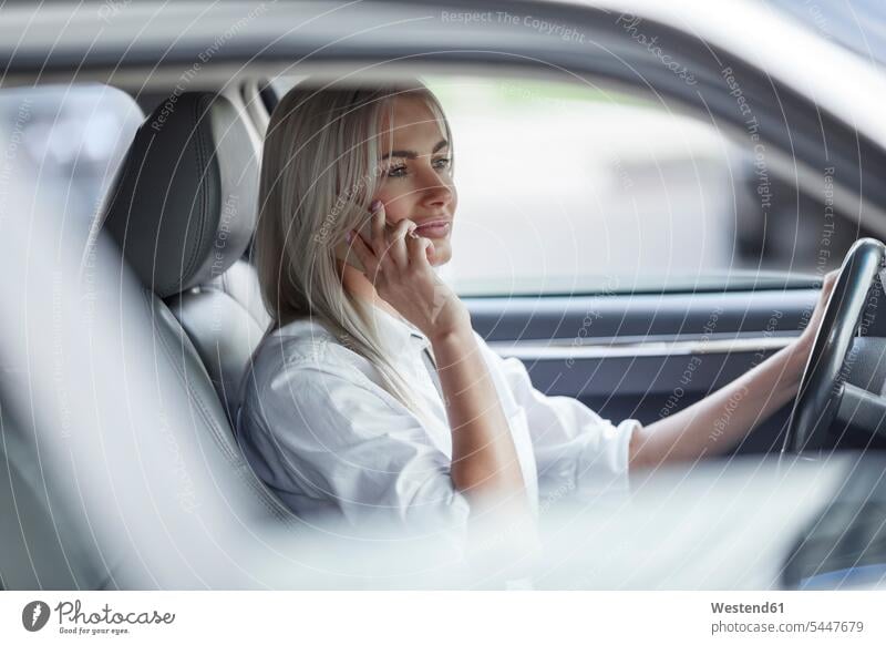 Businesswoman on cell phone driving car businesswoman businesswomen business woman business women on the phone call telephoning On The Telephone calling females
