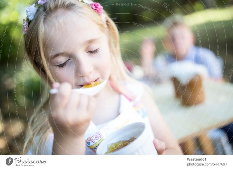 Girl eating jelly outdoors girl females girls child children kid kids people persons human being humans human beings Jelly Jello Pudding Puddings Sweet Food