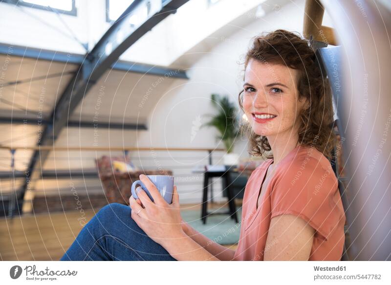Portrait of smiling woman having a coffee break in modern office Coffee offices office room office rooms females women smile sitting Seated Drink beverages