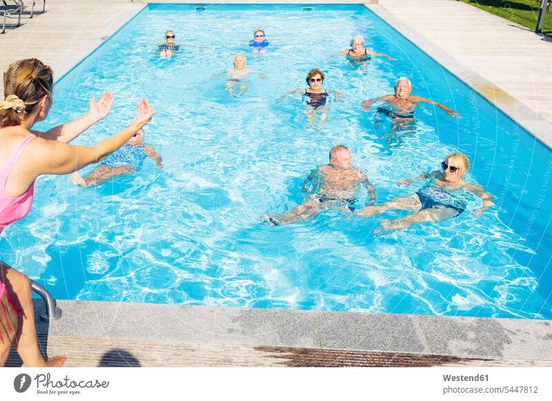 Group of seniors with trainer doing water gymnastics in pool aqua aerobics senior adults old swimming pool pools swimming pools group of people groups of people