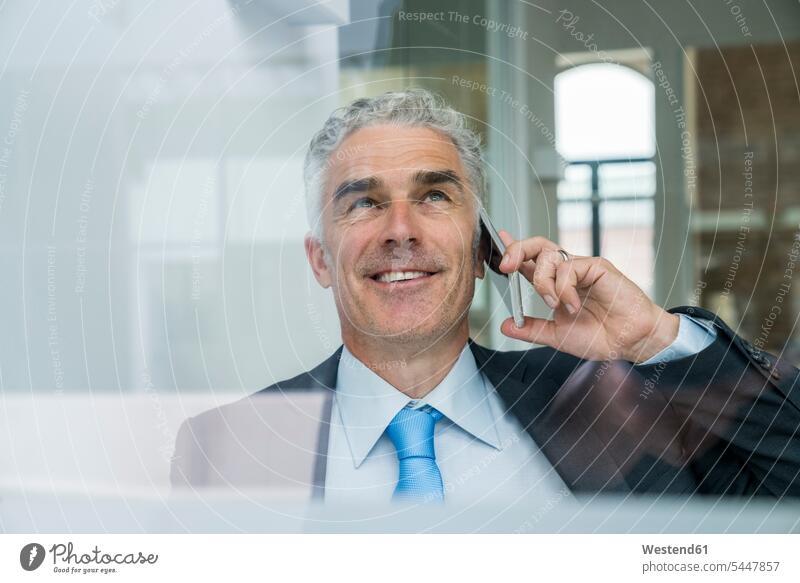 Mature businessman talking on the phone mobile phone mobiles mobile phones Cellphone cell phone cell phones Success successful manager managers office offices