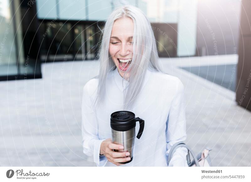 Screaming young businesswoman holding coffee mug in the city businesswomen business woman business women portrait portraits Coffee females screaming shouting
