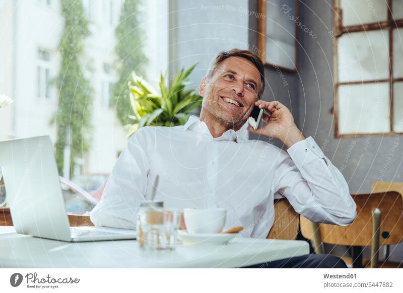 Smiling businessman on the phone in cafe mobile phone mobiles mobile phones Cellphone cell phone cell phones portrait portraits call telephoning