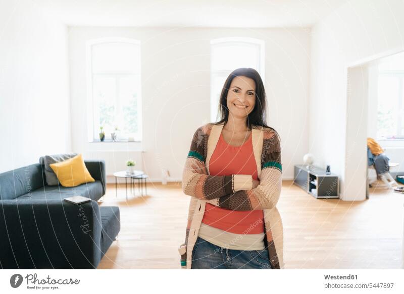 Portrait of happy woman at home standing smiling smile females women Adults grown-ups grownups adult people persons human being humans human beings flat flats