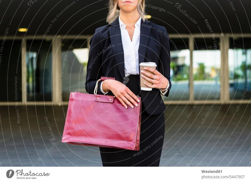Businesswoman with fashionable red leatherbag and coffee to go, partial view businesswoman businesswomen business woman business women leather bag leather bags