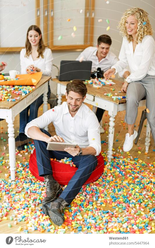 Creative professionals meeting in office surrounded by colorful polystyrene parts Fun having fun funny colleagues Business Meeting business conference offices