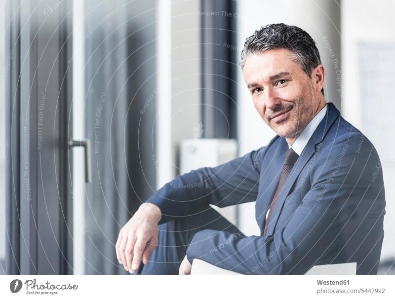 Portrait of smiling businessman in office offices office room office rooms Businessman Business man Businessmen Business men portrait portraits smile workplace