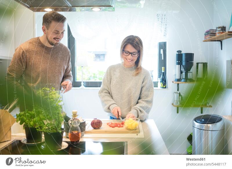 Happy couple preparing salad in kitchen together Salad Salads happiness happy home at home twosomes partnership couples Food foods food and drink Nutrition